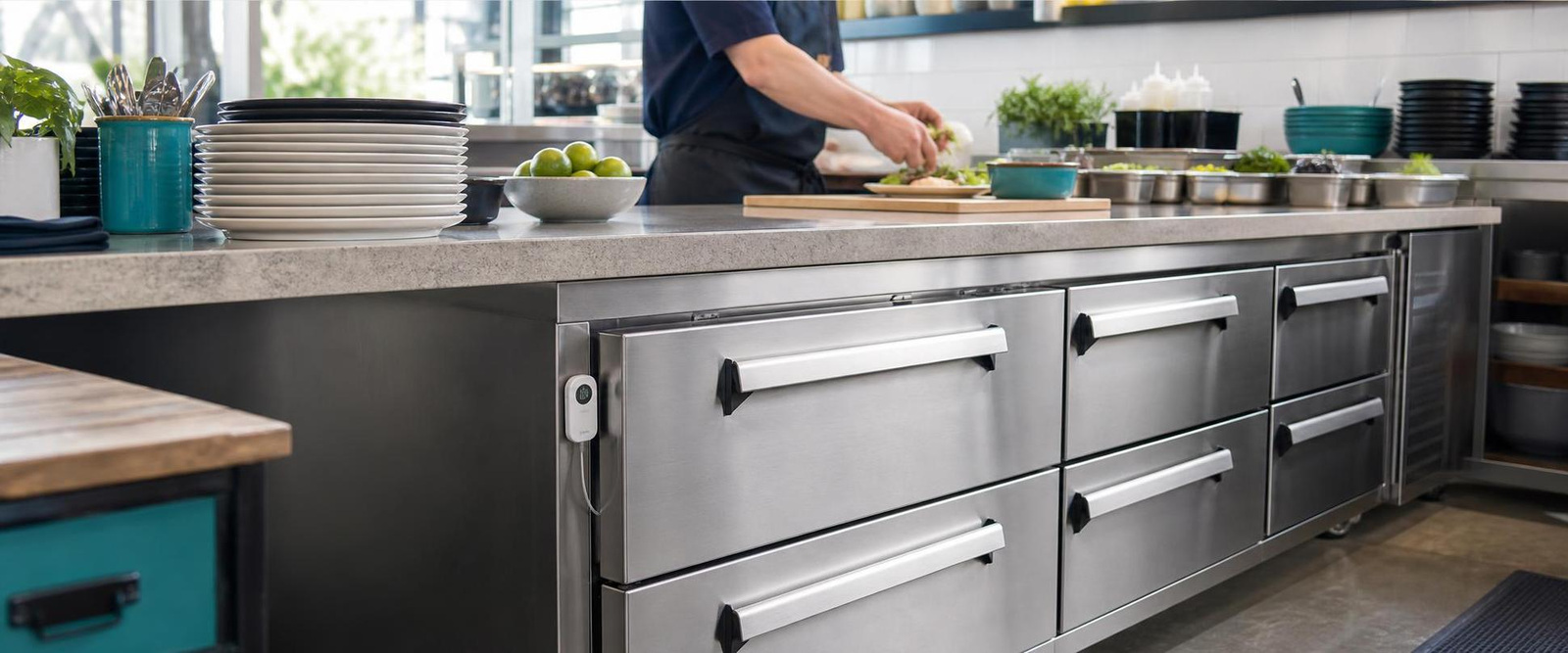 MOCREO MS3 monitoring a restaurant under-counter freezer during daytime food preparation